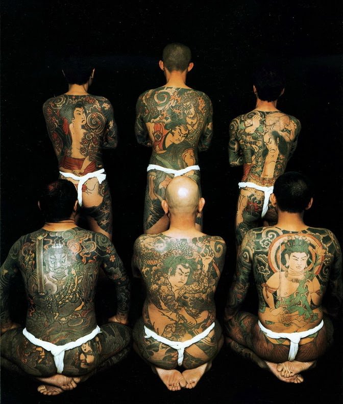 Yakuza-gang-members-pose-for-a-photograph-that-shows-their-traditional-irezumi-tattoo-designs